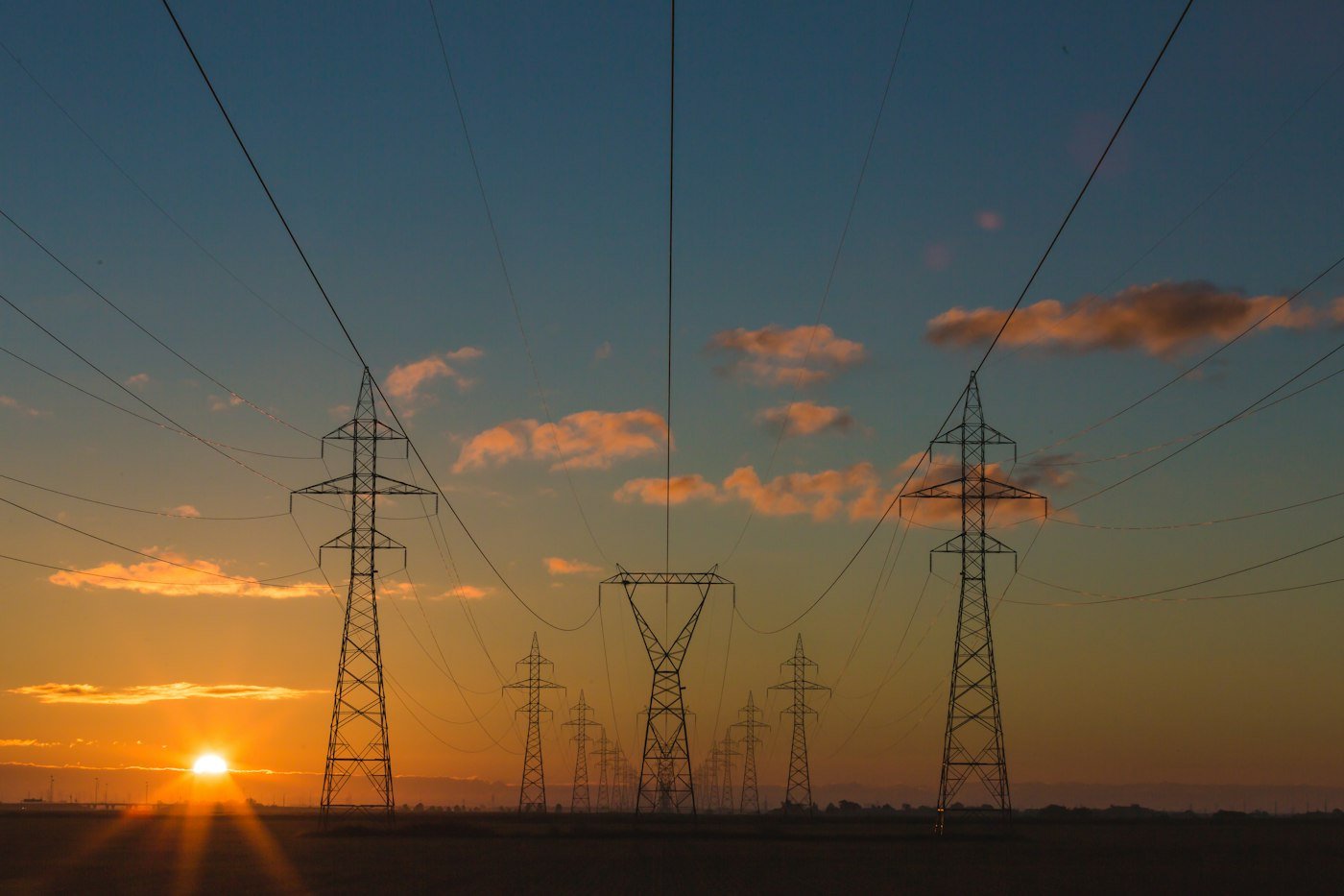 Intact high-voltage transmission lines at sunset