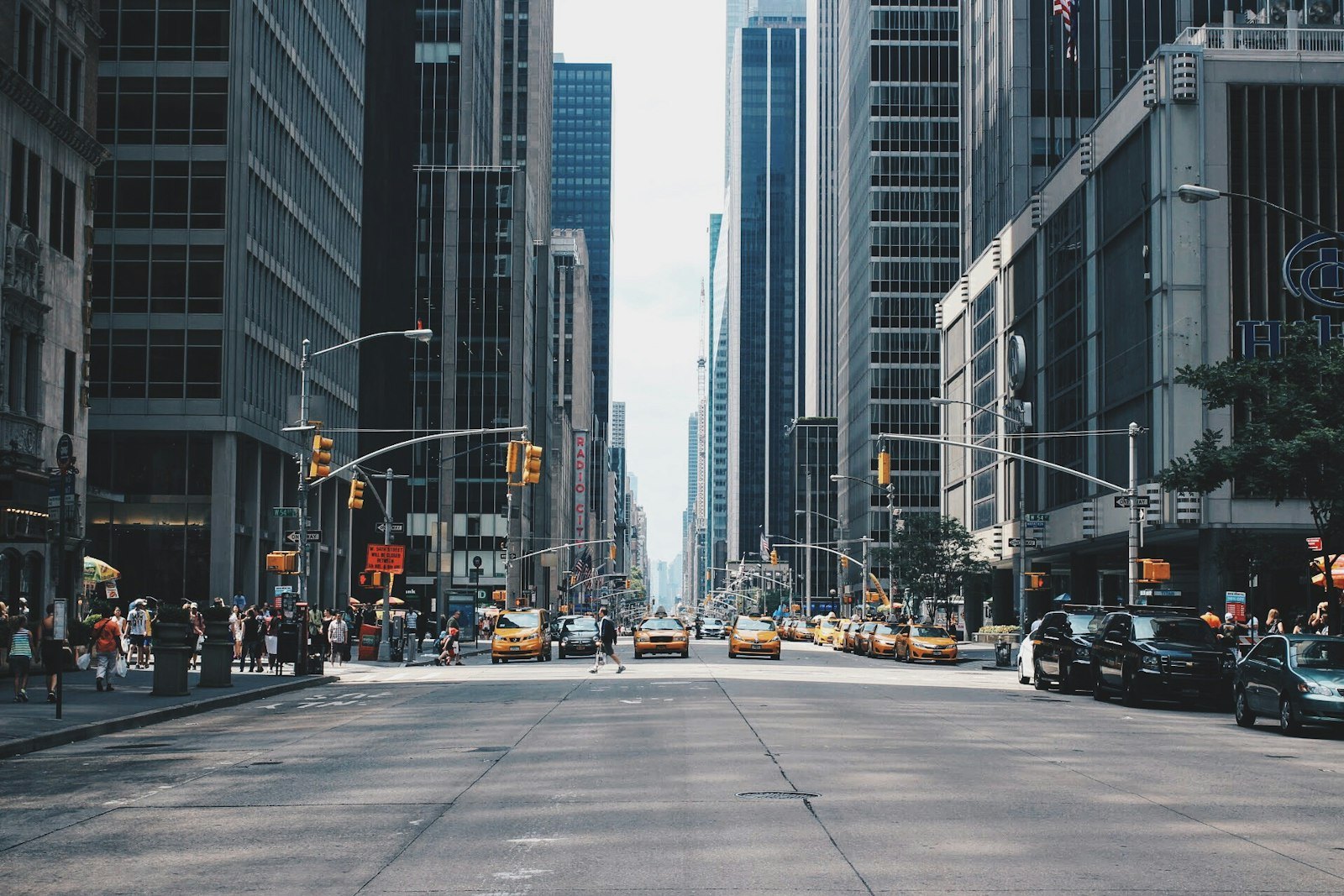 Clean Midtown Manhattan avenue with working traffic and clear sidewalks